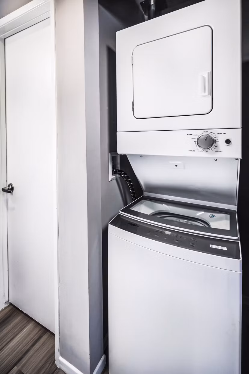 Laundry room with modern appliances at Corte Bella Apartments