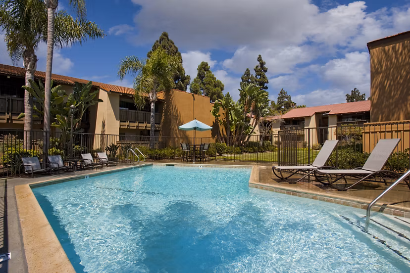 Resort-style pool with lounge seating at Corte Bella Apartments, luxury community with top amenities