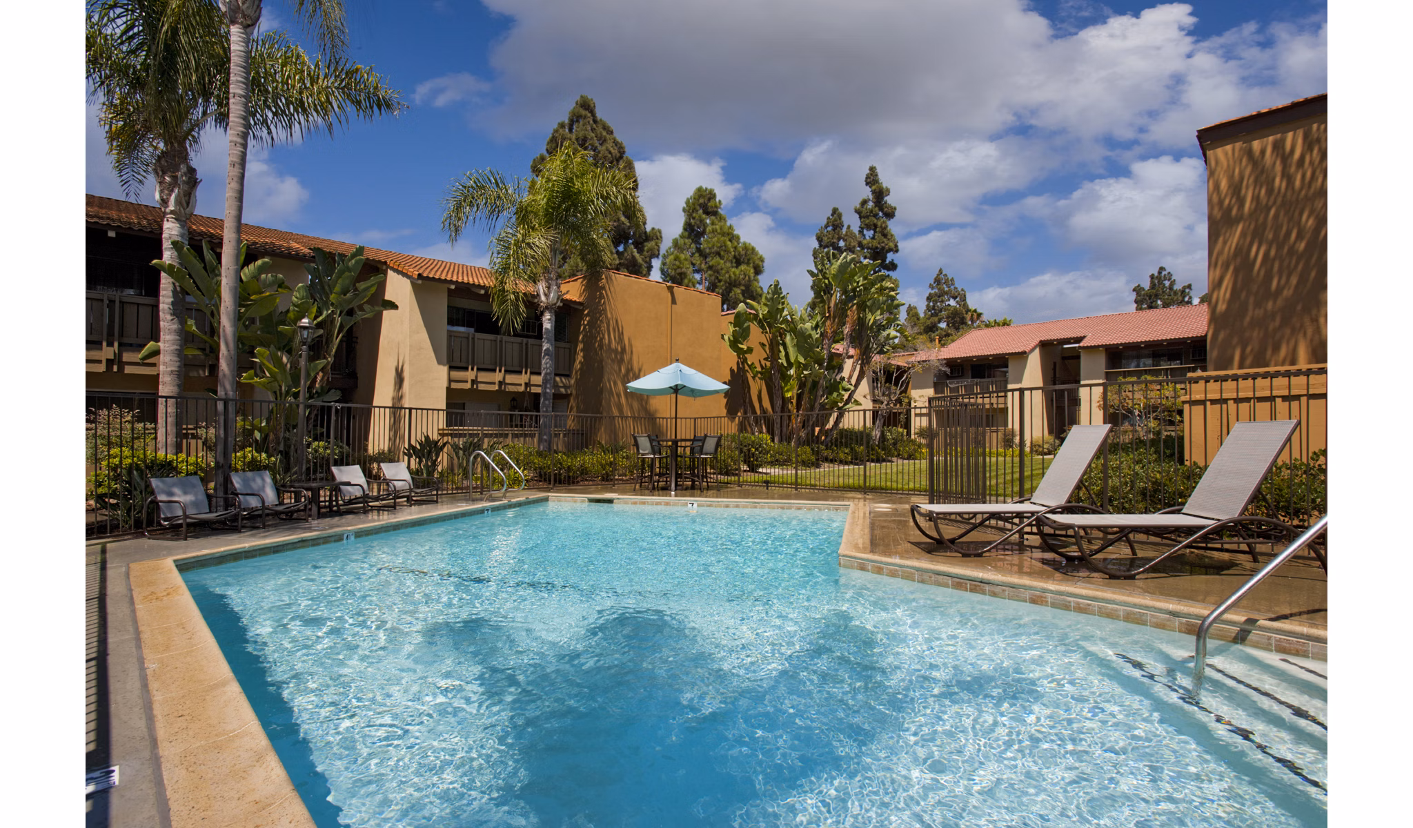 Resort-style pool with lounge seating at Corte Bella Apartments, luxury community with top amenities