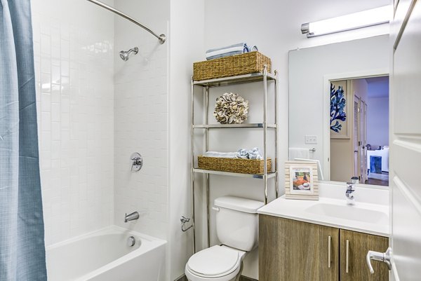 Modern bathroom featuring marble countertops and sleek fixtures at Ocean 650 Apartments