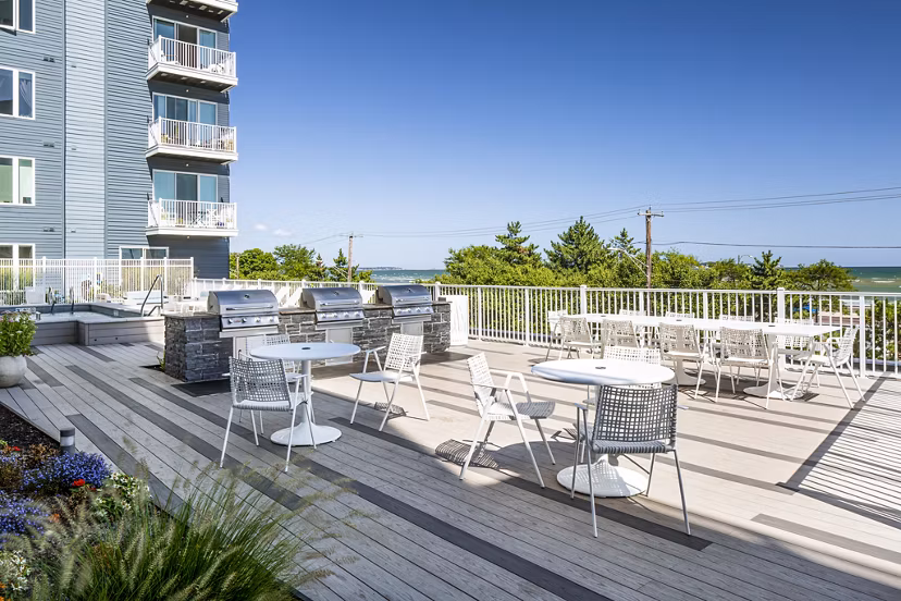 Stylish outdoor grill area with modern seating at Ocean 650 Apartments