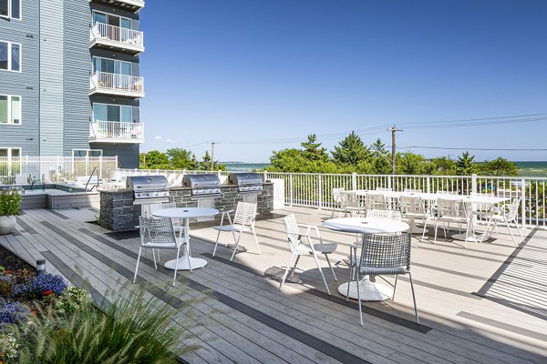 Stylish outdoor grill area with modern seating at Ocean 650 Apartments