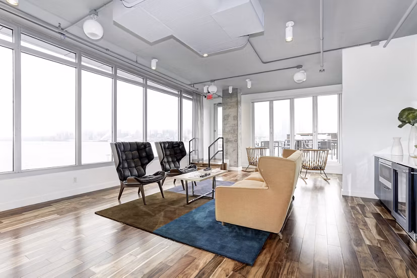 Harbor 1500: Spacious living room with large windows, stylish furniture, and hardwood floors in luxury apartments