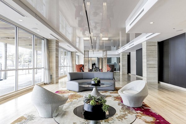 Sleek lobby with contemporary furniture and large windows at Harbor 1500 Apartments