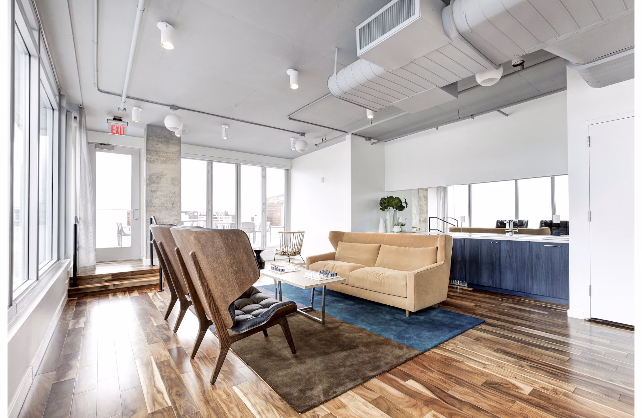 Modern living room with wooden floors and stylish furniture in Harbor 1500 luxury apartments overlooking the water