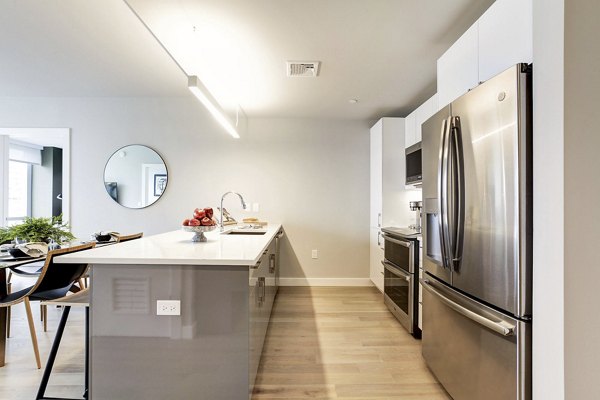 Modern kitchen with stainless steel appliances and white cabinets at Harbor 1500 Apartments in Weehawken, offering luxury living spaces