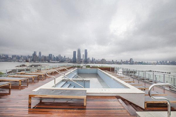 Rooftop pool with city skyline view at Harbor 1500 Apartments in cloudy weather