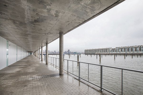 Covered walkway by the water with cityscape in background at Harbor 1500 Apartments in Edgewater offering scenic views