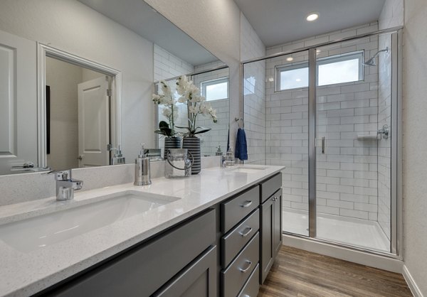 Modern bathroom featuring elegant marble countertops and a spacious shower in Pradera Luxury Rental Homes