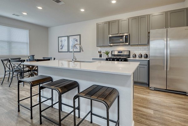 Modern kitchen with stainless steel appliances at Pradera Luxury Rental Homes