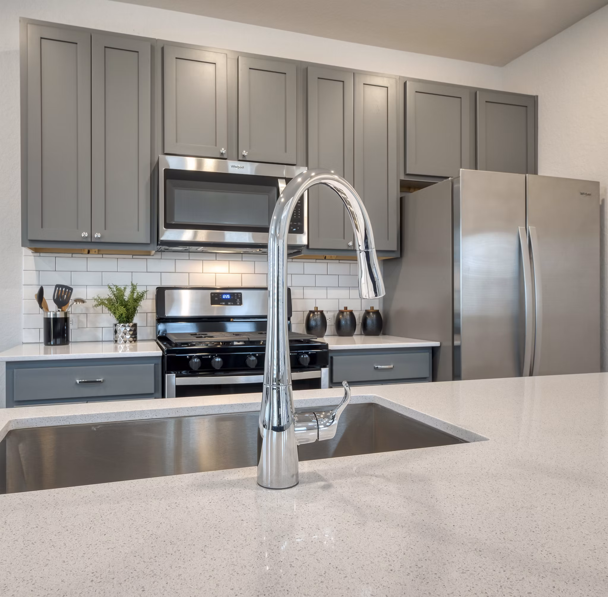 Modern kitchen with stainless steel appliances in Pradera Luxury Rental Homes, offering upscale living spaces for comfort and style