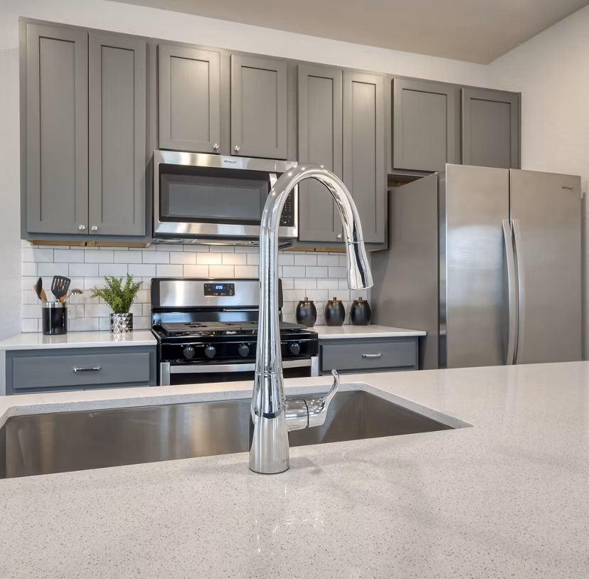 Modern kitchen with stainless steel appliances in Pradera Luxury Rental Homes, offering upscale living spaces for comfort and style