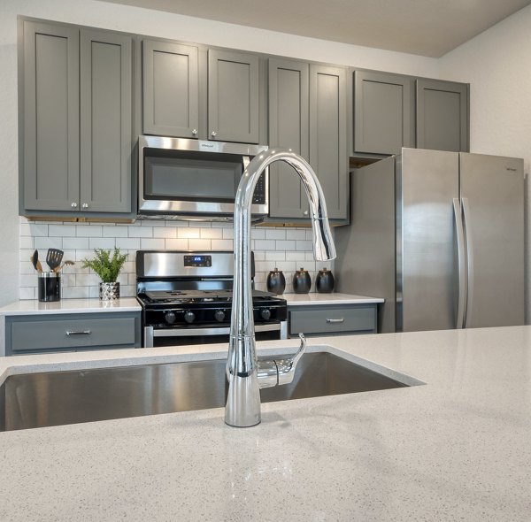 Modern kitchen with stainless steel appliances in Pradera Luxury Rental Homes, offering upscale living spaces for comfort and style