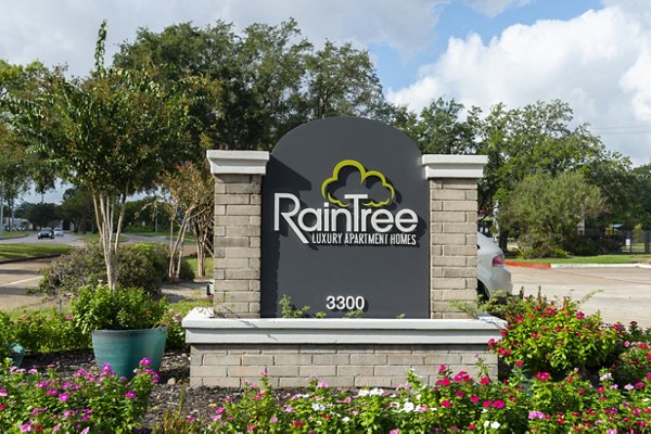 Raintree Apartments: Modern signage displaying property name at luxury community entrance