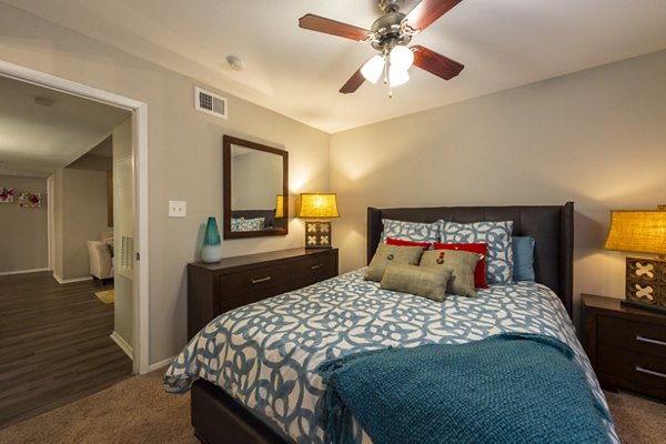 Cozy bedroom with modern furnishings in Raintree Apartments