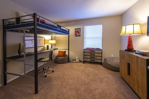 Cozy bedroom with natural light at Raintree Apartments luxury complex