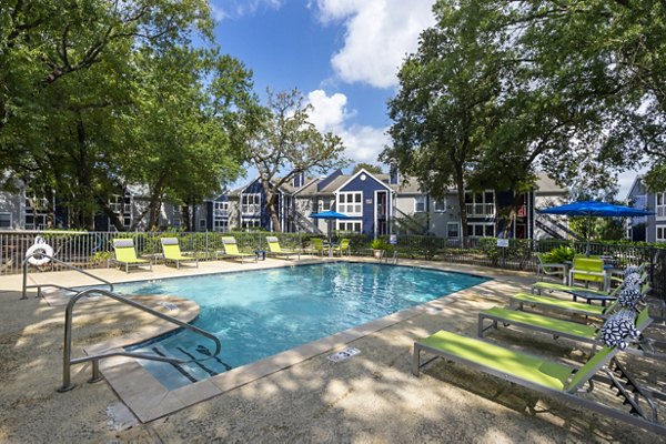 Spacious outdoor pool area at Raintree Apartments offering luxurious relaxation