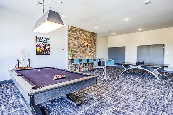 Clubhouse game room featuring pool table and lounge seating in College View Apartments, a luxury community by Greystar