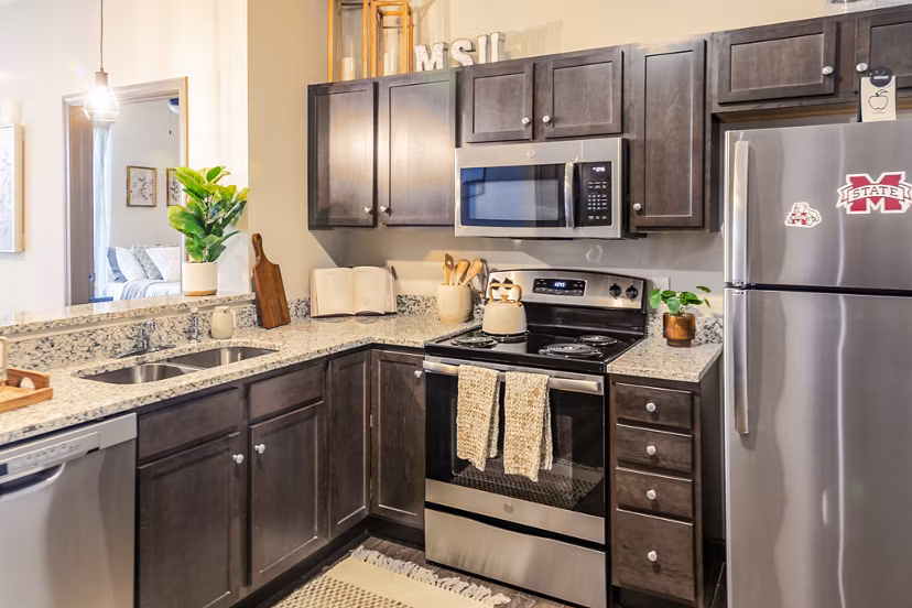 Contemporary kitchen with stainless steel appliances at College View Apartments
