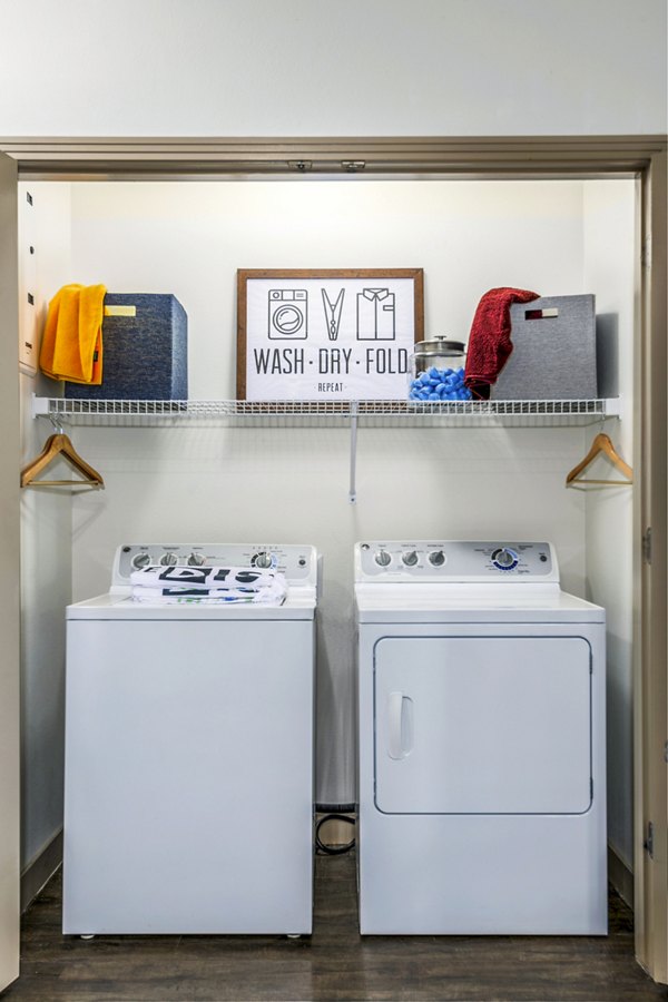 laundry room at The District on Apache Apartments