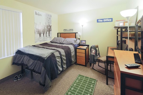 Bright bedroom with large windows and modern decor at Evergreen Commons Apartments, a Greystar luxury apartment offering comfort and style