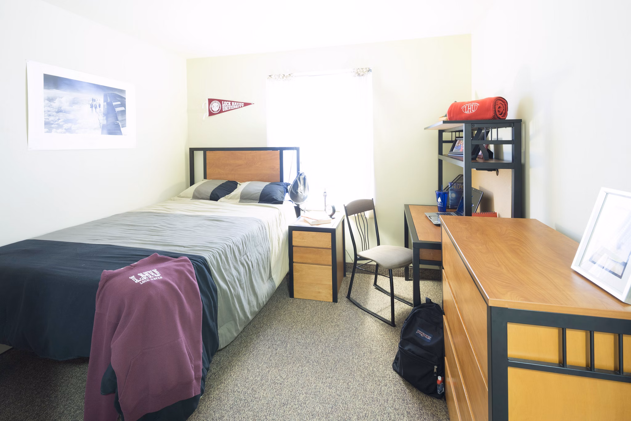 Elegant bedroom with large windows at Evergreen Commons Apartments