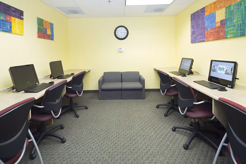 Business center featuring modern workstations at Evergreen Commons Apartments