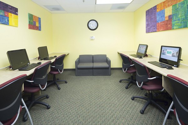Business center featuring modern workstations at Evergreen Commons Apartments
