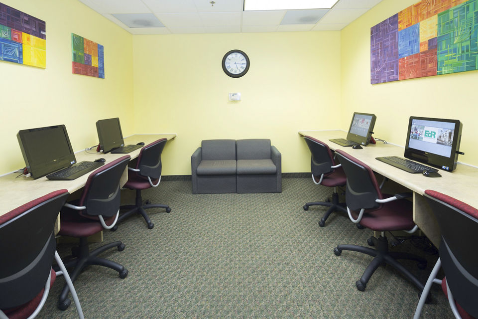 Business center featuring modern workstations at Evergreen Commons Apartments