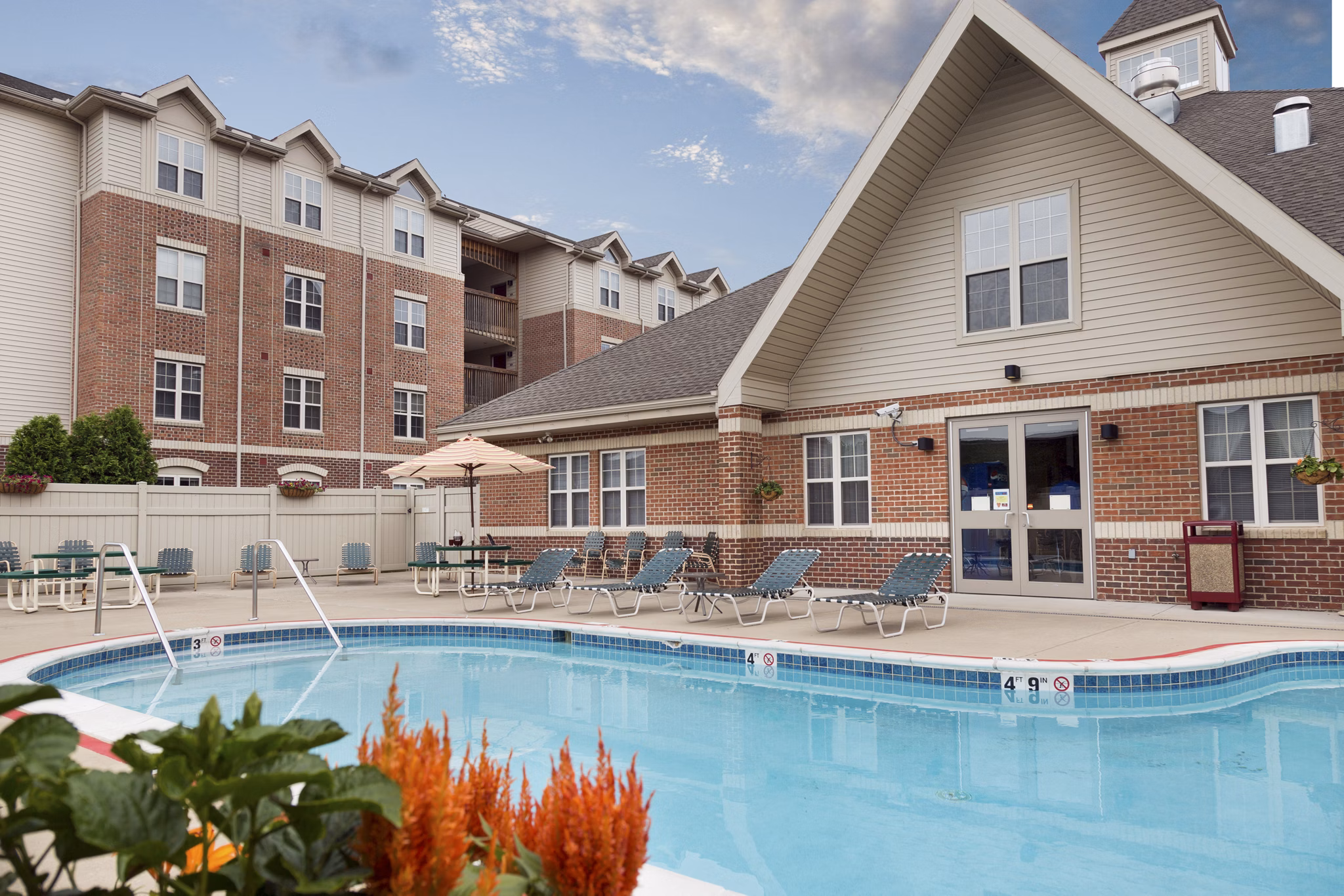 Sparkling outdoor pool at Evergreen Commons Apartments, perfect for relaxation and leisure in a luxurious setting