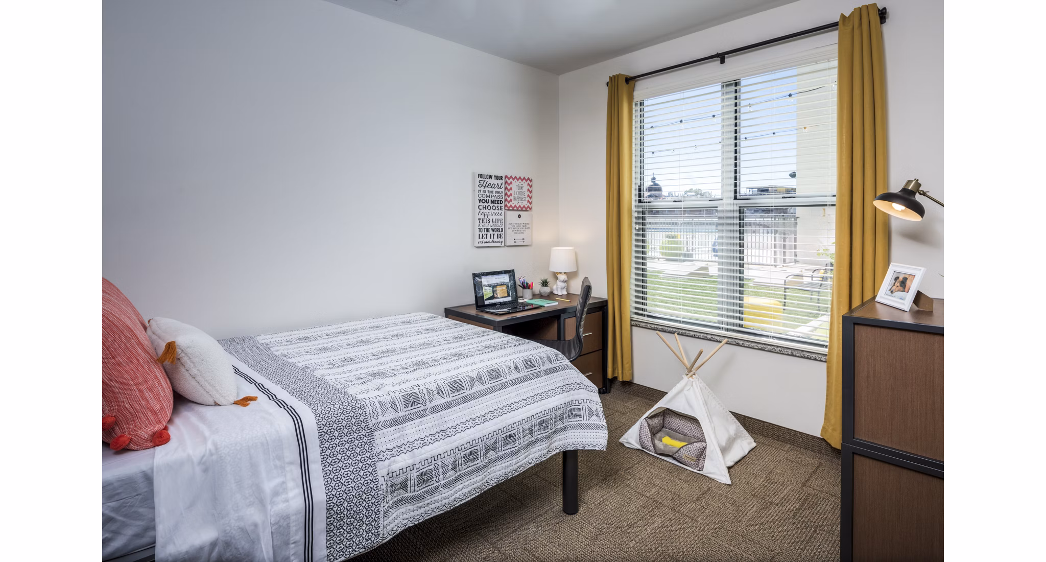 Cozy bedroom with modern decor at The Local Downtown Apartments