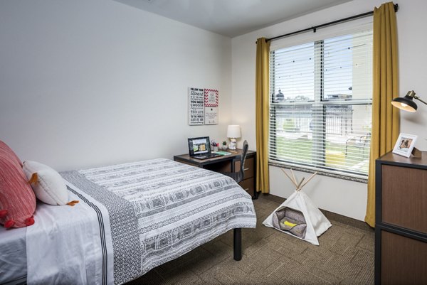 Cozy bedroom with modern decor at The Local Downtown Apartments