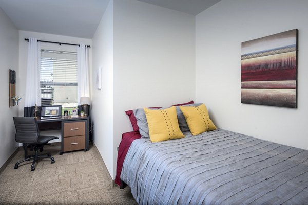 Spacious bedroom with modern decor at The Local Downtown Apartments