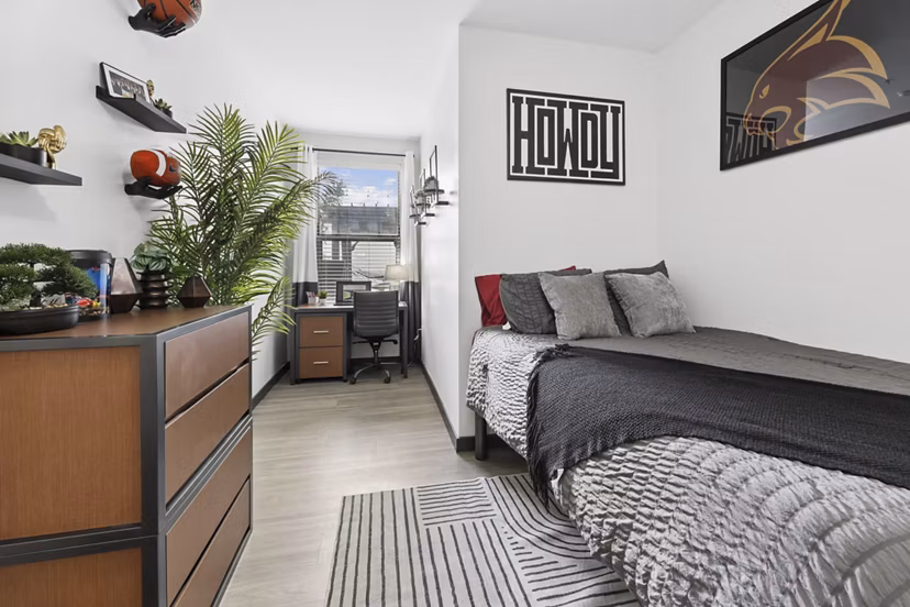 Bedroom featuring modern furniture and stylish decor at The Local Downtown Apartments