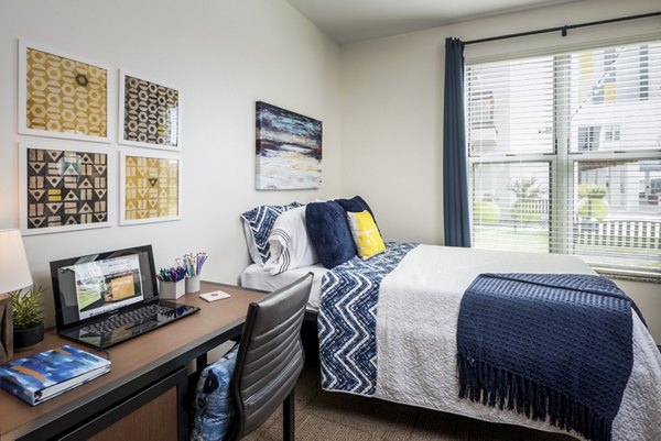 Bedroom featuring modern furniture and stylish decor at The Local Downtown Apartments