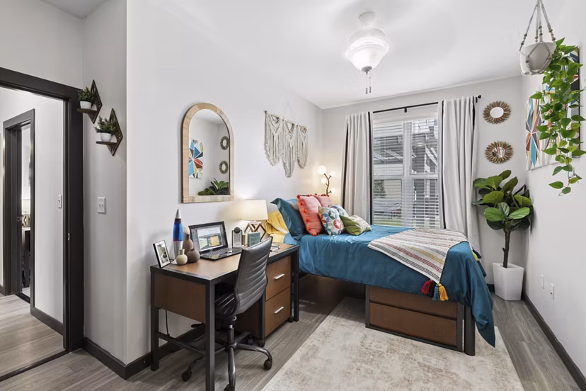 Cozy bedroom with modern decor at The Local Downtown Apartments