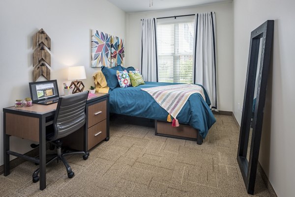 Cozy bedroom with modern decor at The Local Downtown Apartments