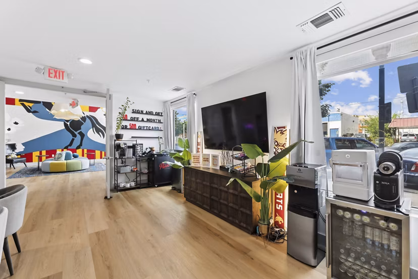 Game room with pool table and lounge seating at The Local Downtown Apartments, ideal for socializing and relaxation in urban luxury living