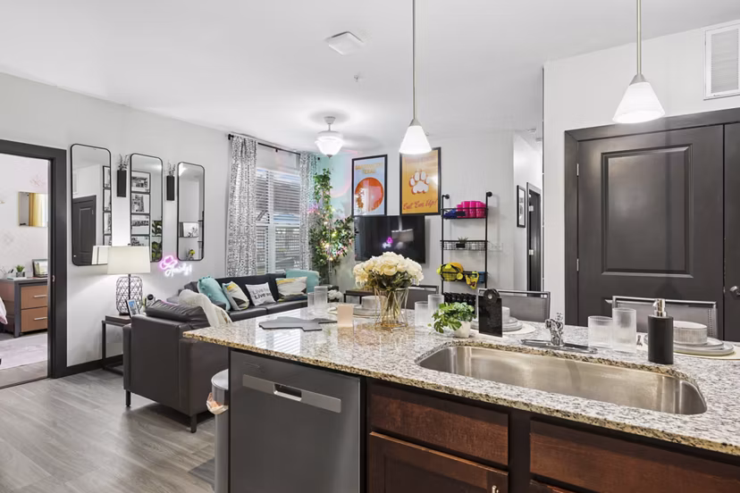 Spacious living room with contemporary furnishings in The Local Downtown Apartments