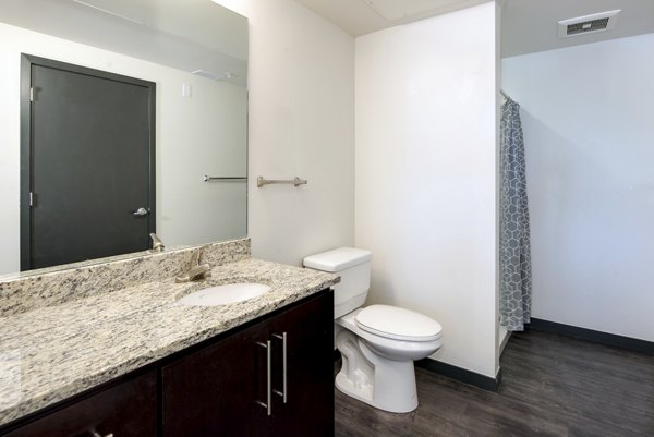 Modern bathroom with marble countertops and sleek fixtures at Lokal Apartments