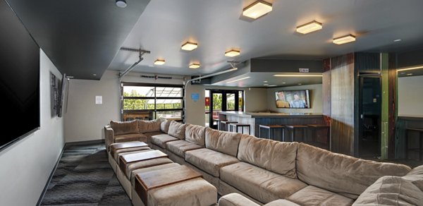 Theater room with plush seating and large screen at Lokal Apartments, a Greystar property in downtown Bellevue