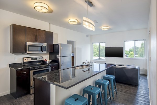 Modern kitchen with stainless steel appliances and marble countertops in Lokal Apartments