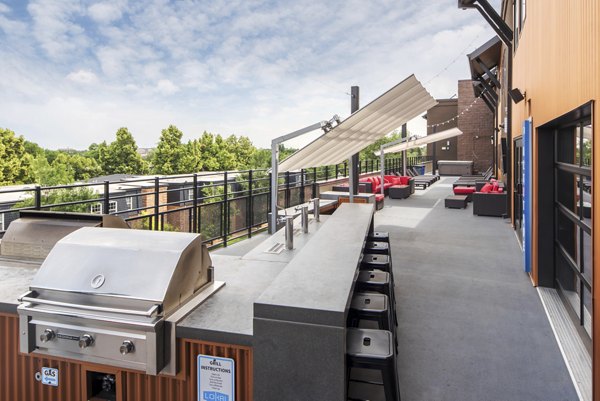 Grill area with seating at Lokal Apartments: Outdoor BBQ space for gatherings
