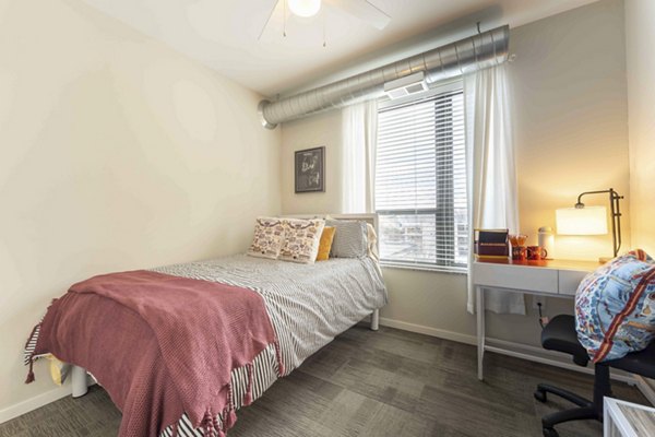 Modern bedroom with sleek furniture and large window at The Marshall Apartments