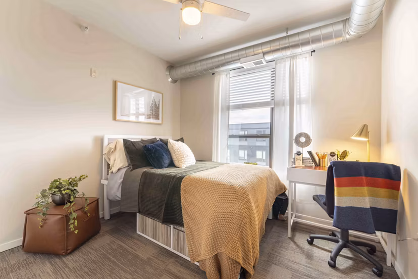 Cozy bedroom with modern decor at The Marshall Apartments
