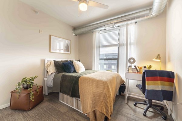 Cozy bedroom with modern decor at The Marshall Apartments