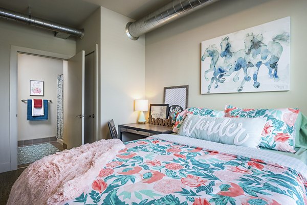 Bedroom featuring modern furnishings and natural light in SkyVue Apartments