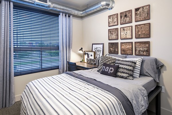 Cozy bedroom with modern furnishings at SkyVue Apartments, luxury living with comfort and style