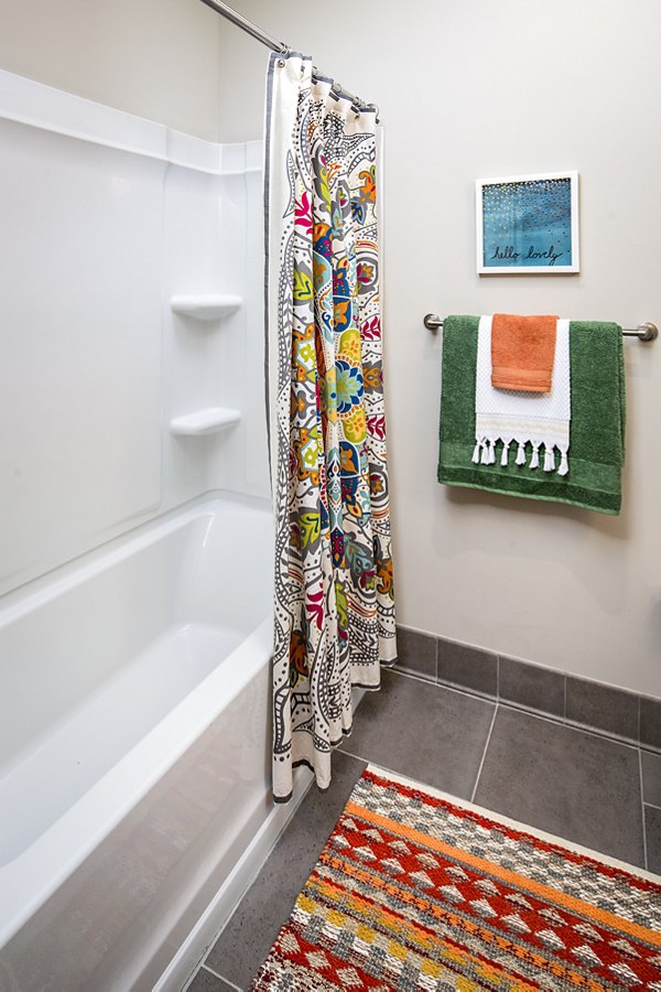 Modern bathroom featuring sleek fixtures and ample storage space at SkyVue Apartments