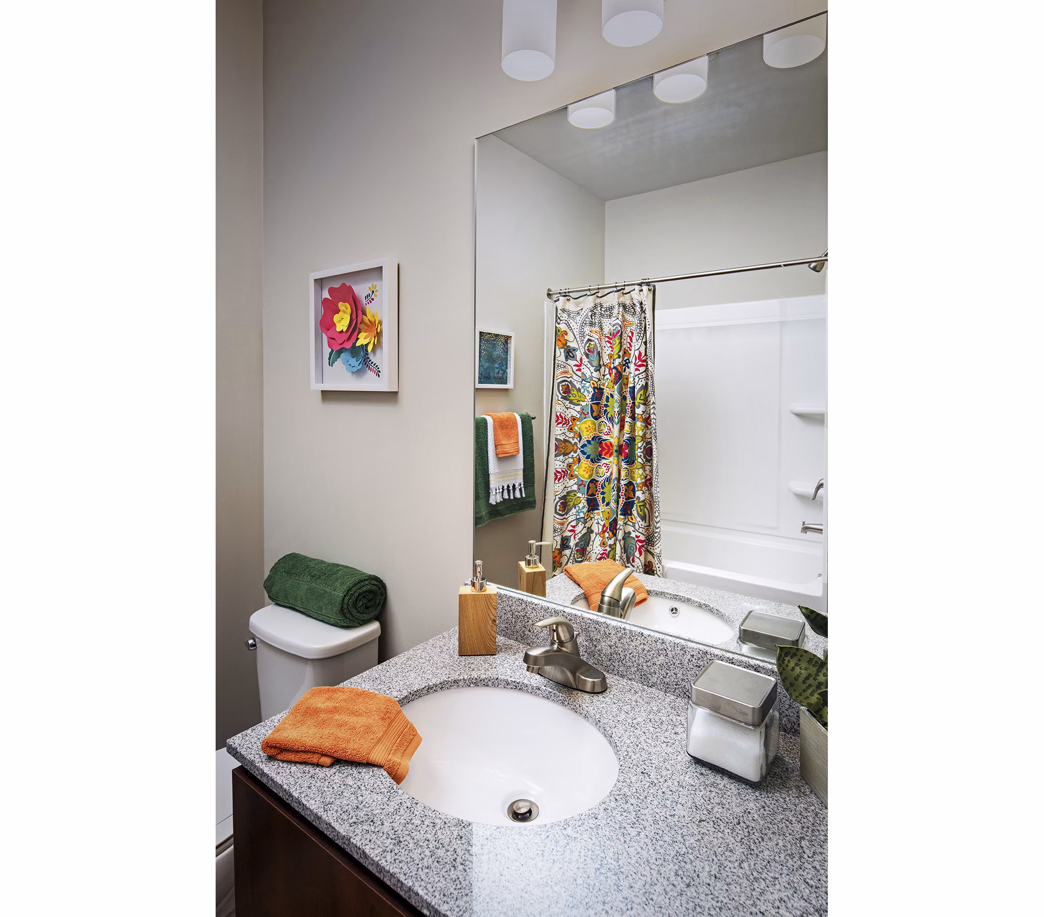Bathroom featuring modern fixtures and elegant tilework at SkyVue Apartments